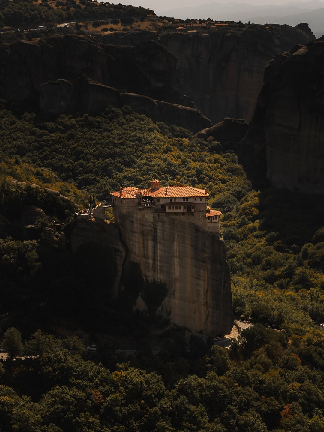 Monasteries of Meteora perched on high rock pillars under soft autumn light.