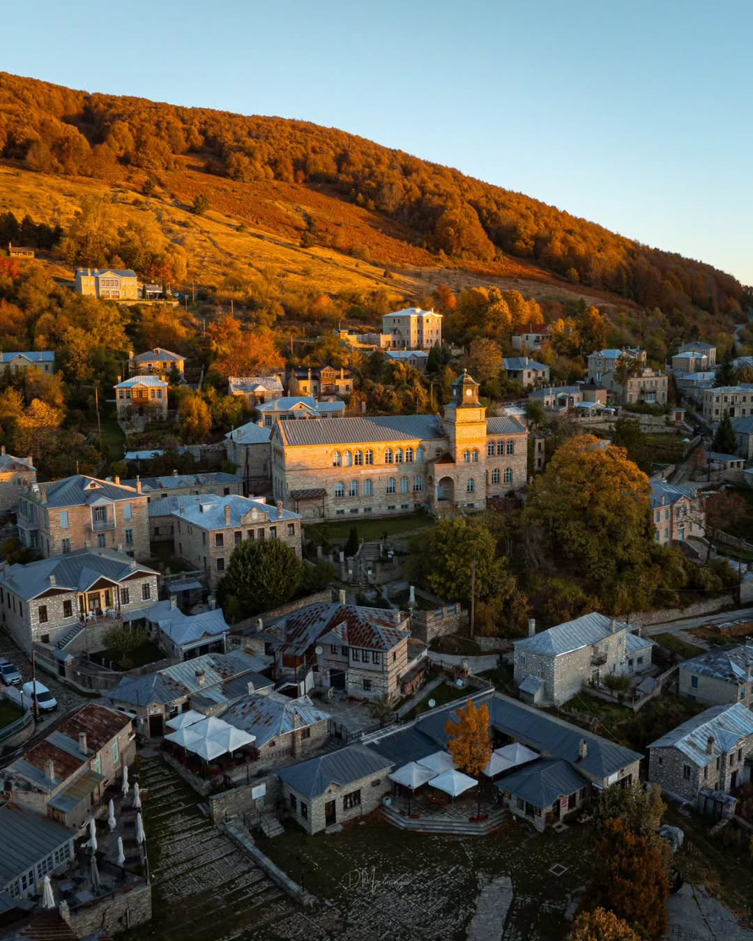 Cobblestone streets and stone guesthouses surrounded by beech forest in Nymfaio village, Florina.