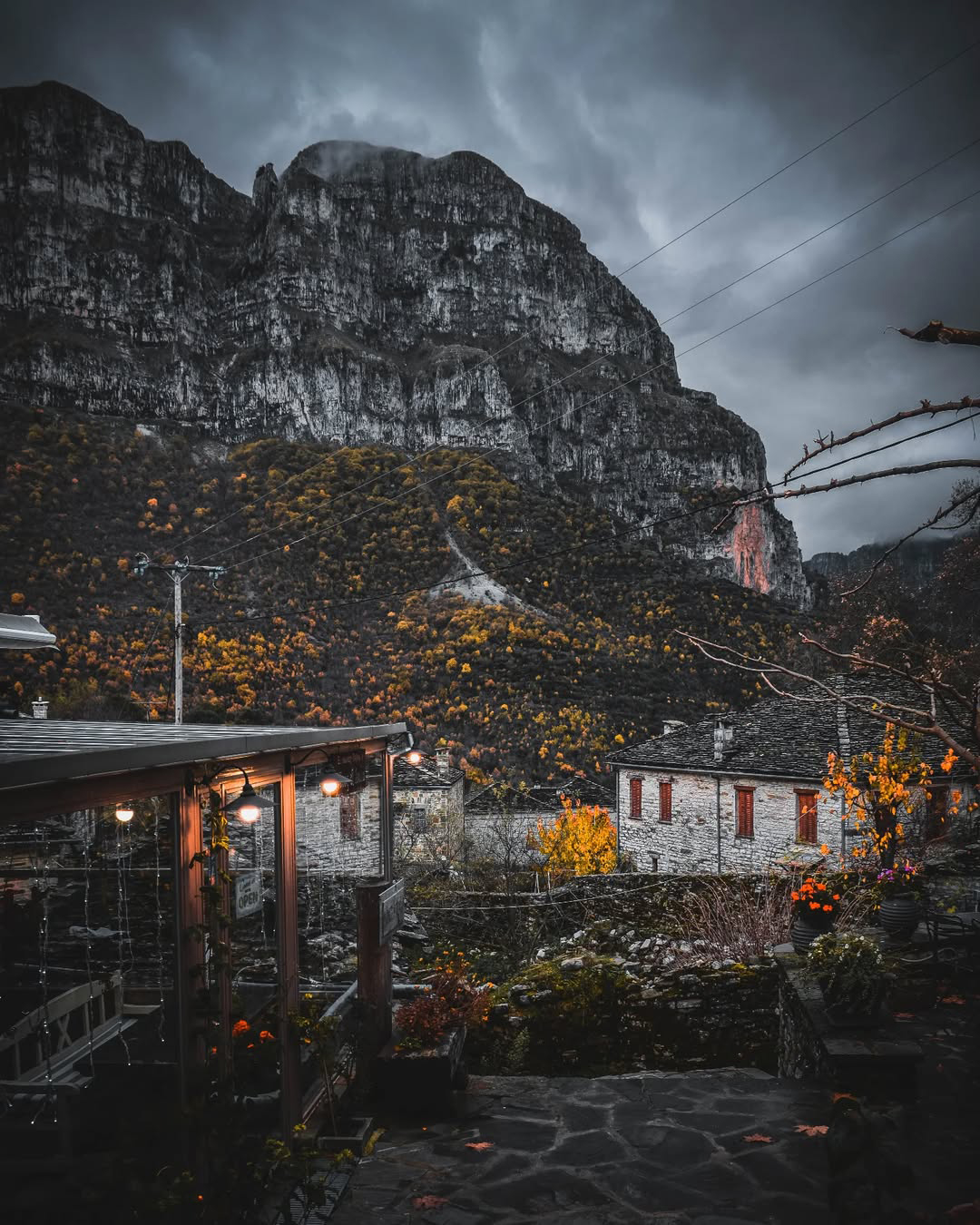 Stone village houses and misty mountains in the Zagori region of Epirus, northern Greece.