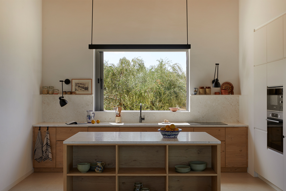 View from the kitchen toward the water court and surrounding landscape
