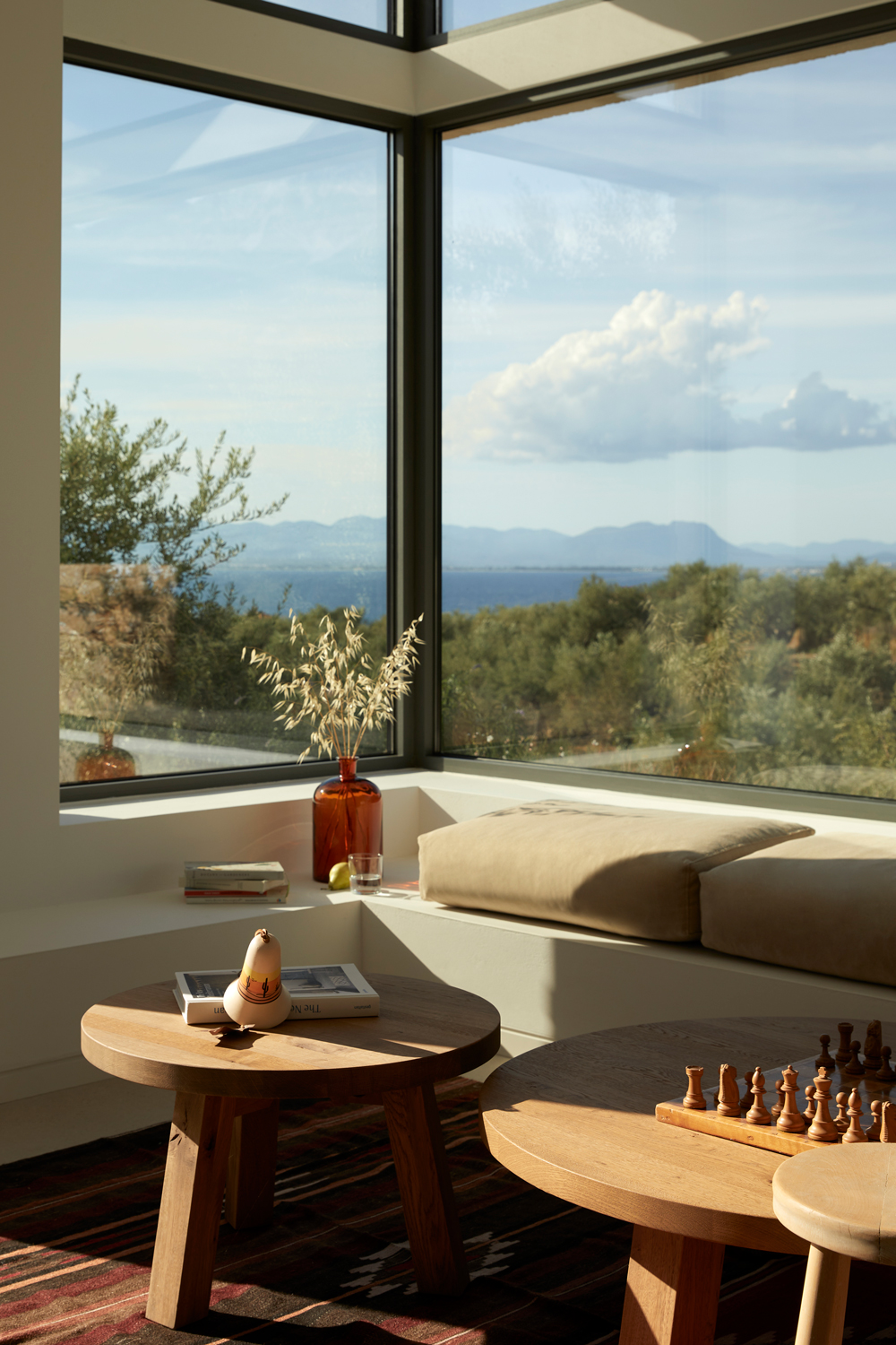 Built-in benches and cool textured floors inside the hillside house