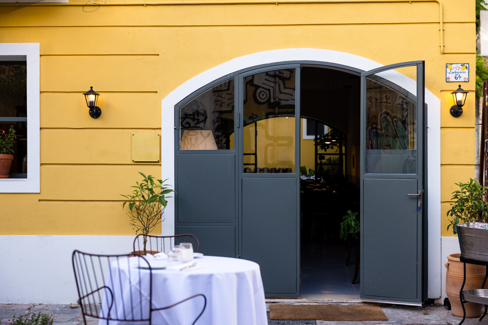 The iron entrance door of Osteria Mamma on Salaminos Street, reminiscent of Italian neighborhood gates.