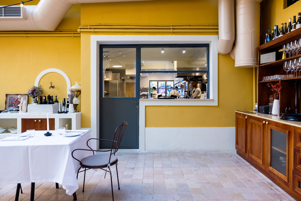 View of the open kitchen connecting the restaurant interior with the courtyard