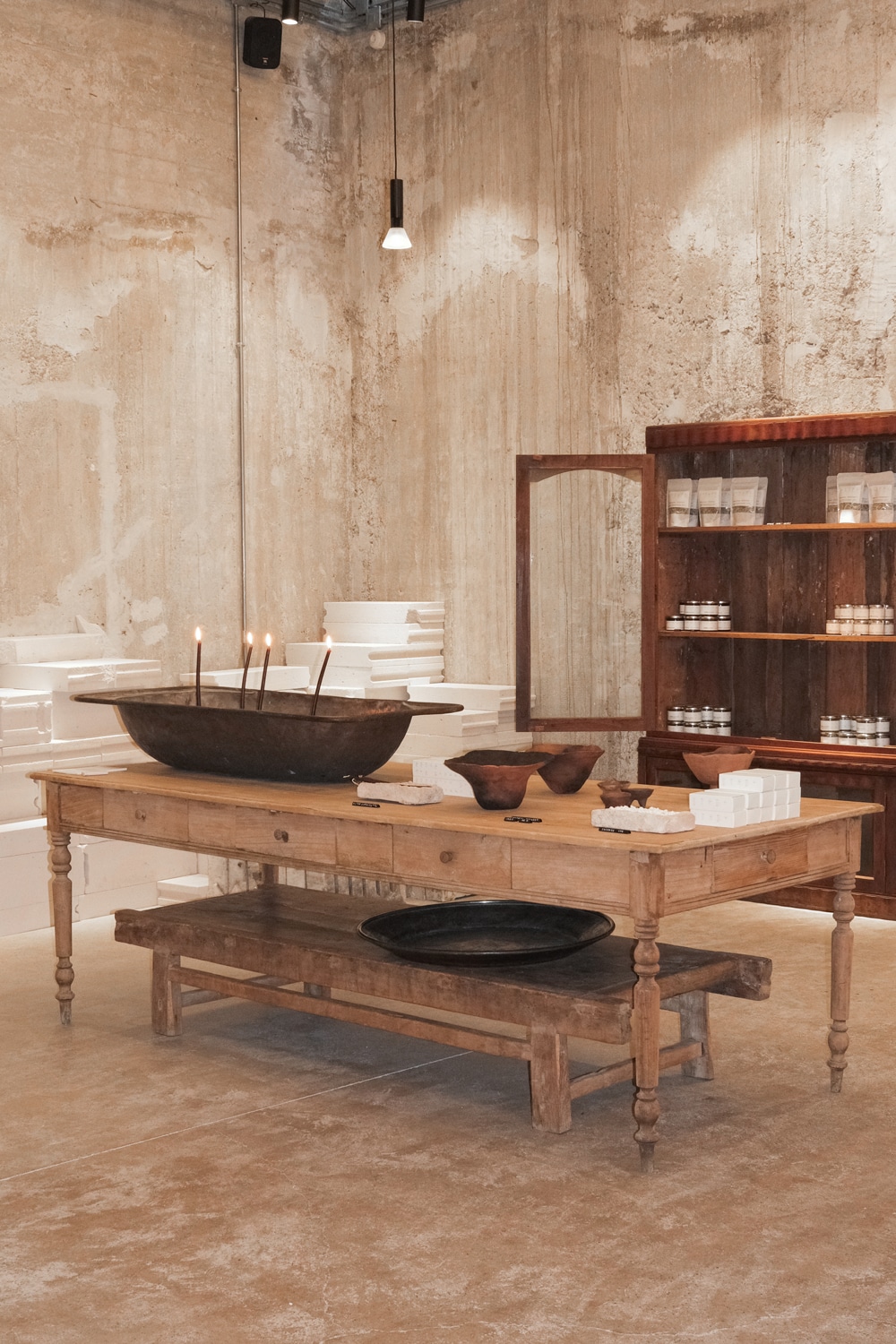 Interior view of the expanded 1OAM apotheke flagship in Athens, featuring natural materials and a minimal, home-like layout.