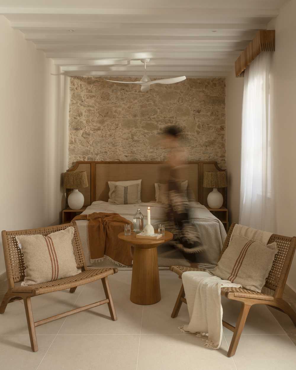 Bedroom at Amarakos with custom wooden furniture and textured linen fabrics