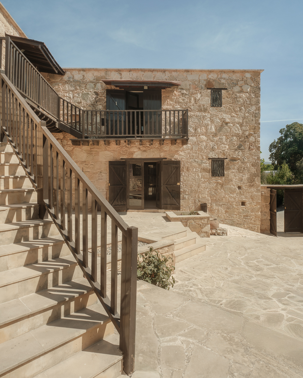 Exterior view of Amarakos wellness retreat in Akourdalia, Cyprus, showing restored stone buildings