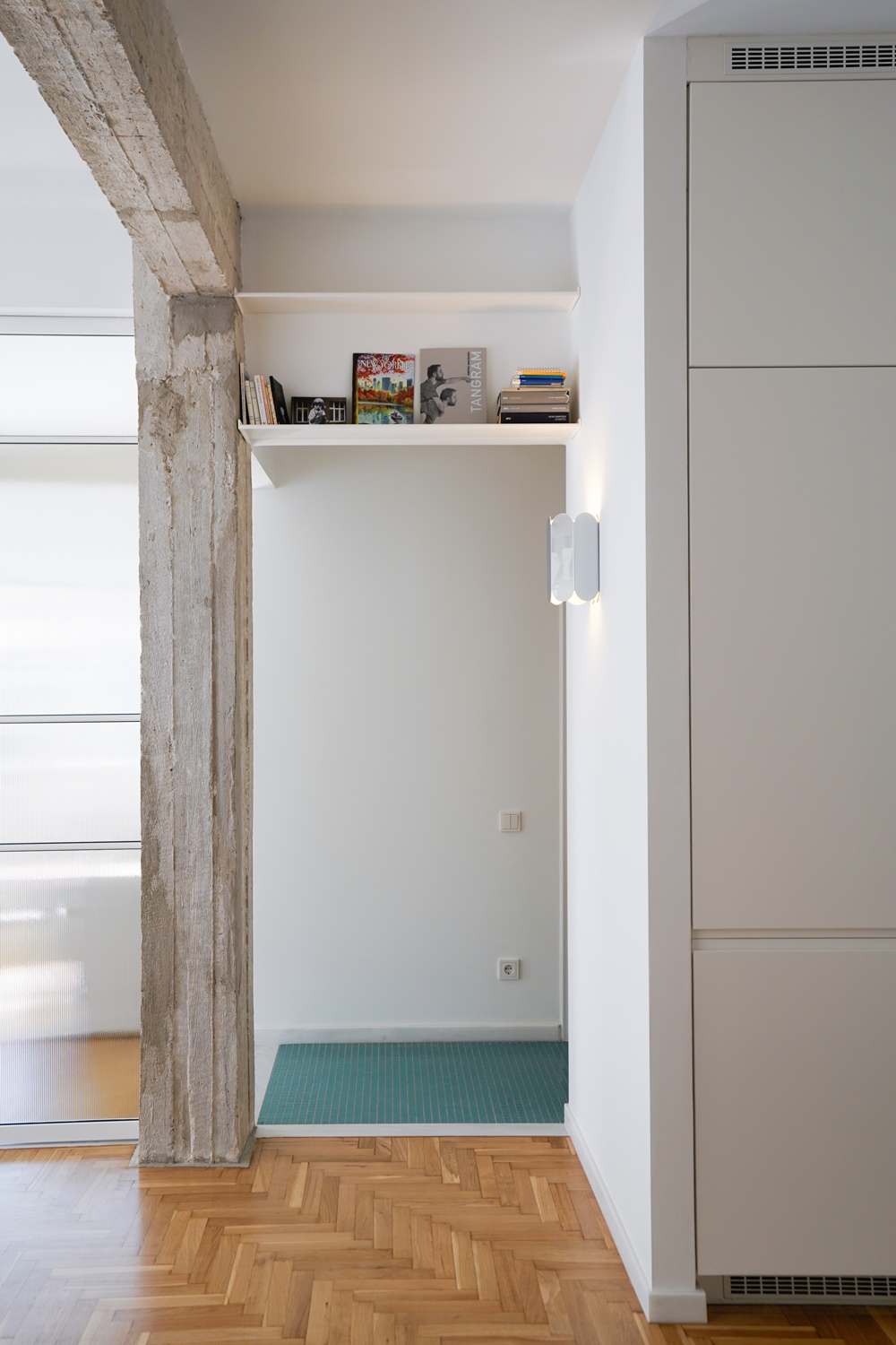 Multi-purpose hallway storage unit combining wardrobe, bench and utility space.