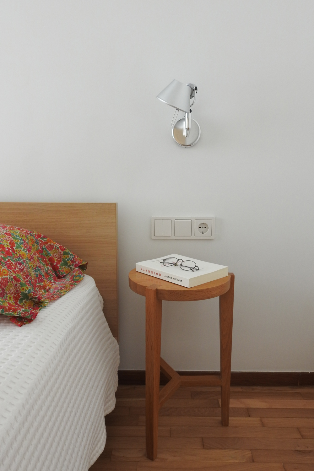 Minimal bedroom featuring restored oak parquet.