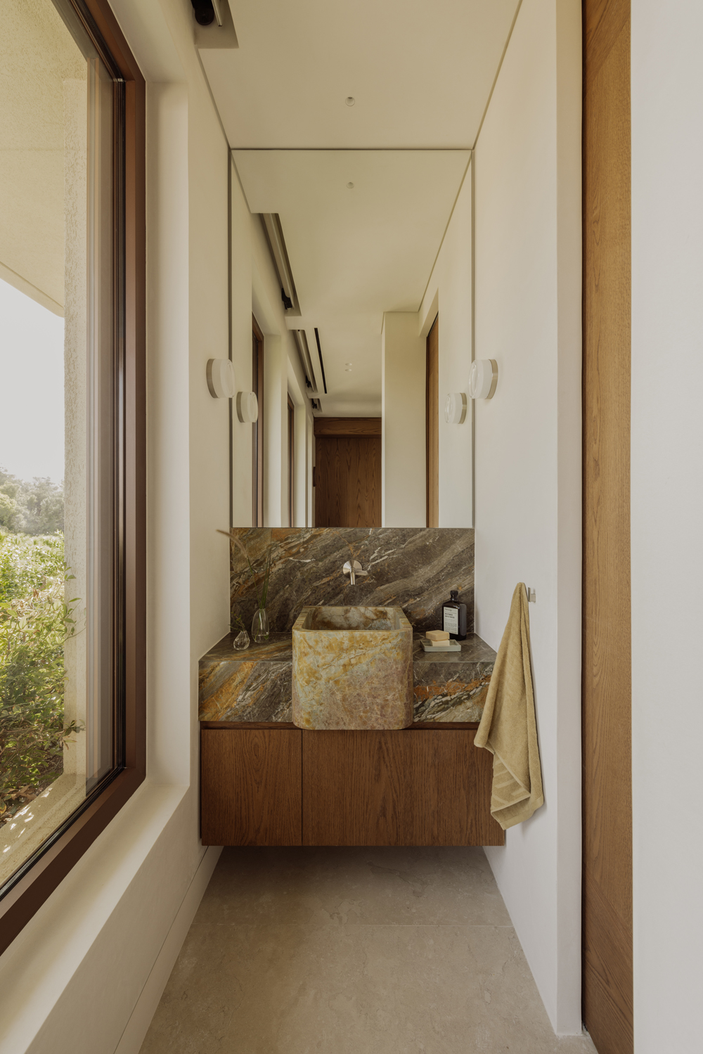 Bathroom interior featuring travertine surfaces and soft natural light.
