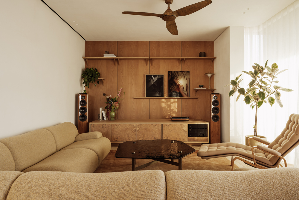 Open-plan living space with custom furniture, natural materials and soft, filtered light.