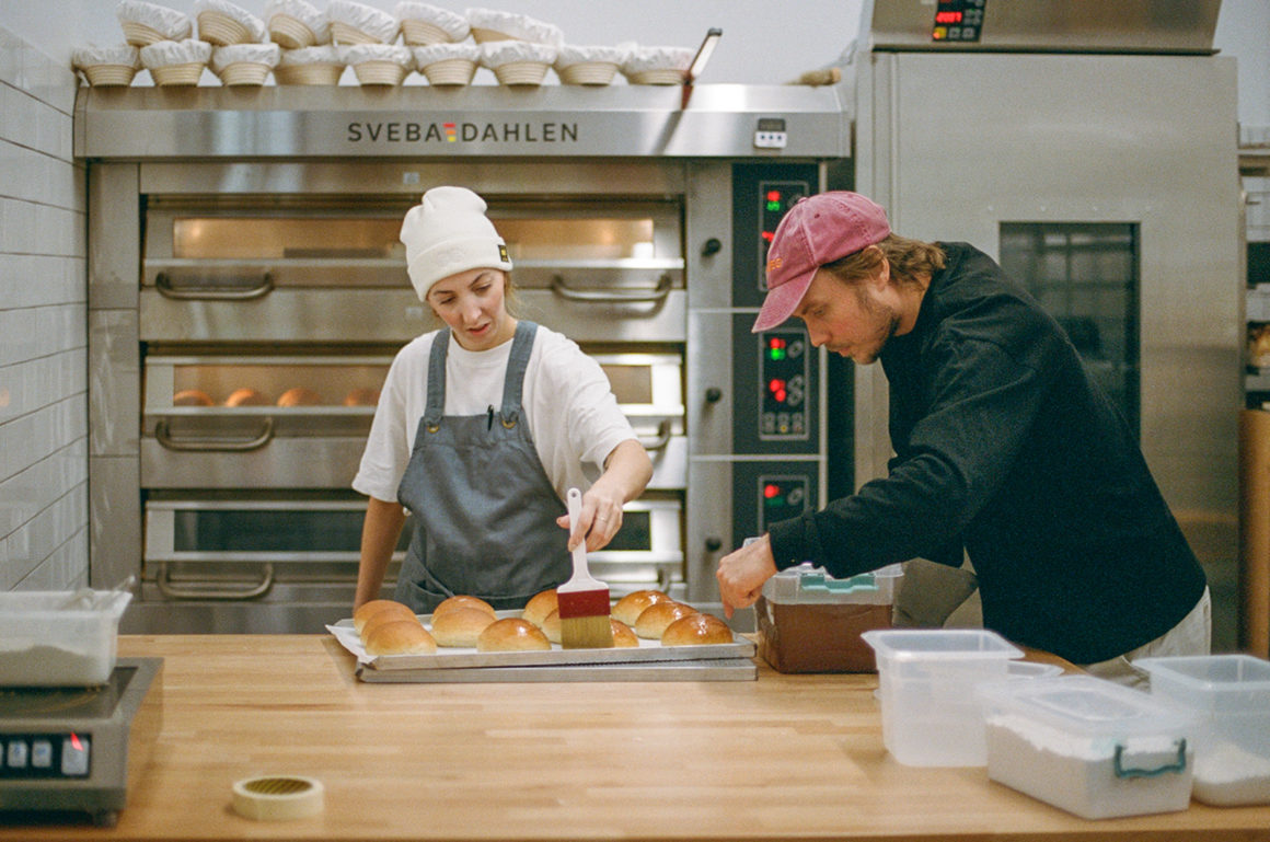 Bakers shaping artisanal loaves at Hygge, inspired by Nordic bread-making practices.