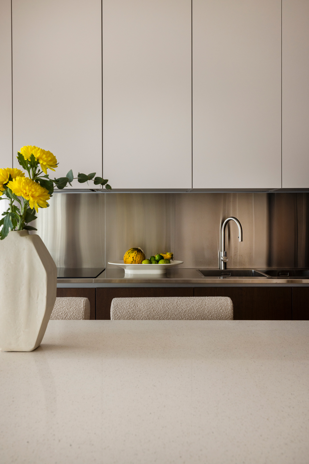 Minimal kitchen with marble surfaces and metal accents