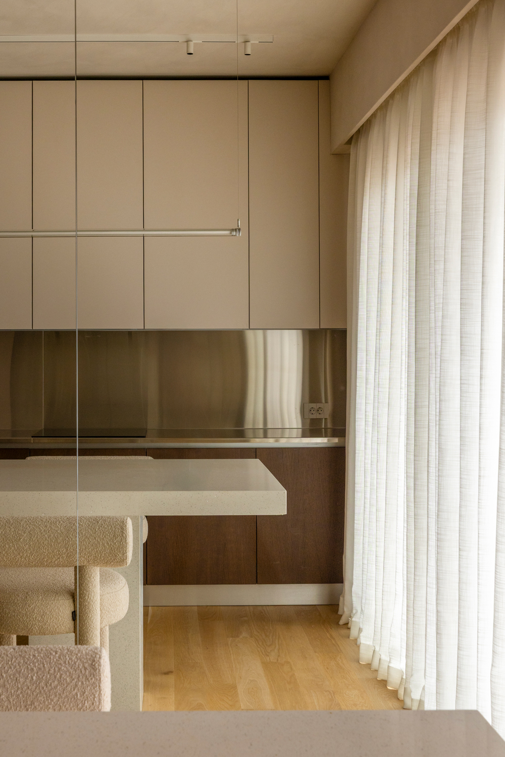 Minimal kitchen with marble surfaces and metal accents