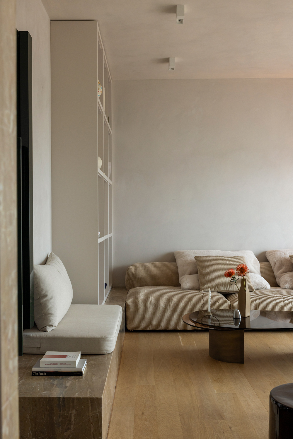 Open-plan living and dining area filled with natural light, featuring mirrored walls and oak flooring.