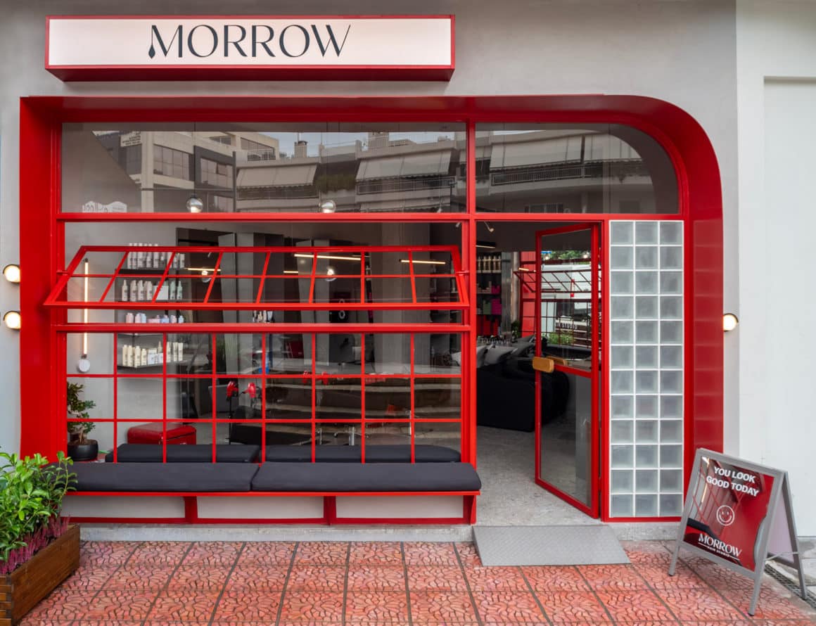 Exterior of MORROW studio with red steel façade and fluted glass panels