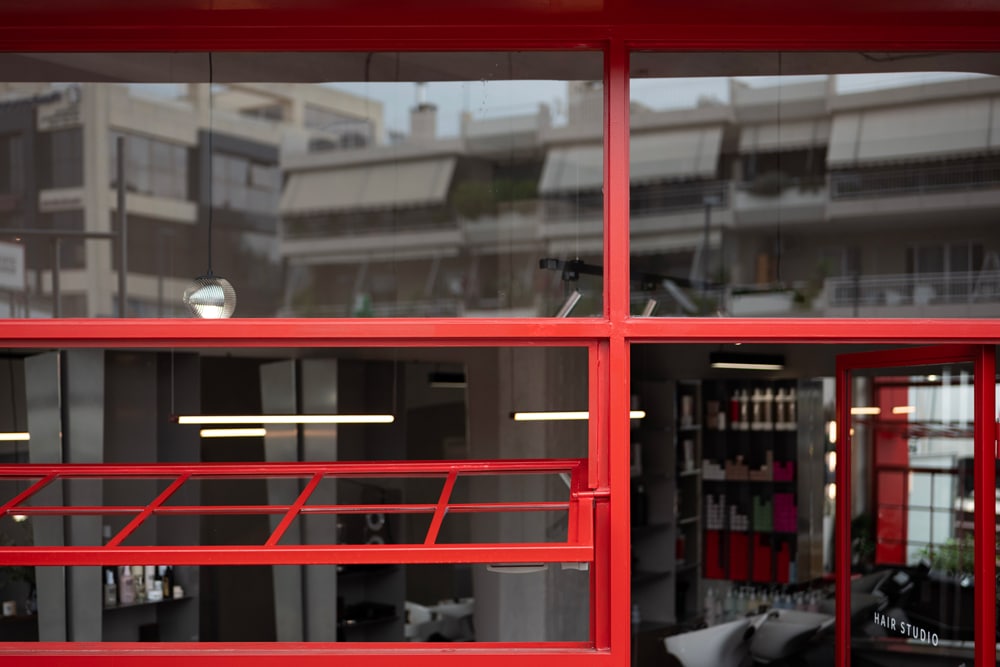 Detail of curved red steel framing on the façade