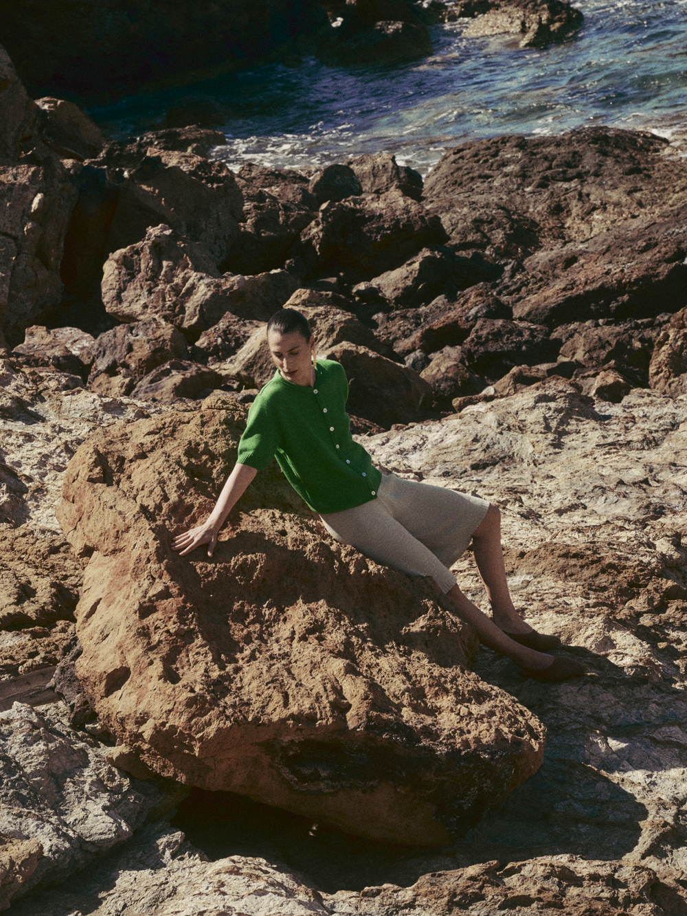 Model posing with green wool sweater from Nonna Lietta