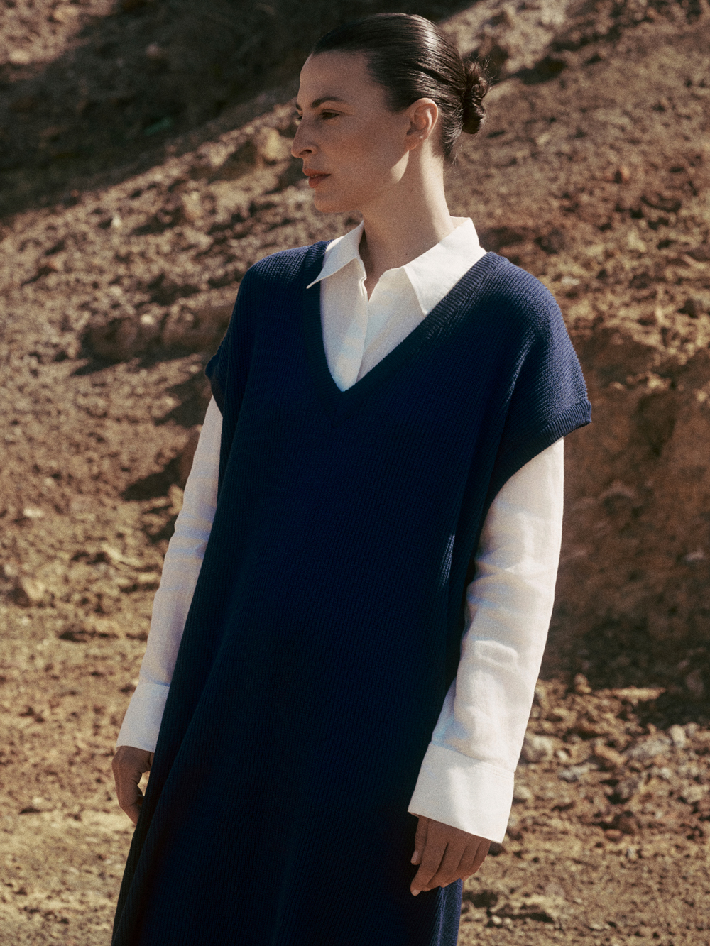 Side profile of a model in a blue jumper from Nonna Lietta