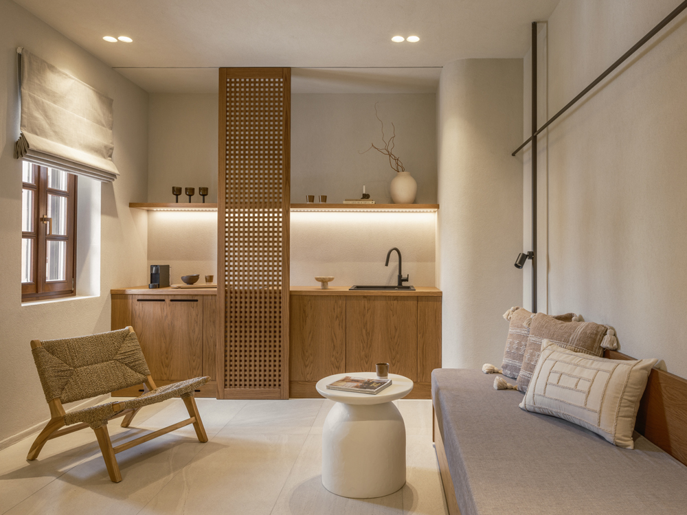 Living area with built-in oak veneer furniture and minimalist décor.