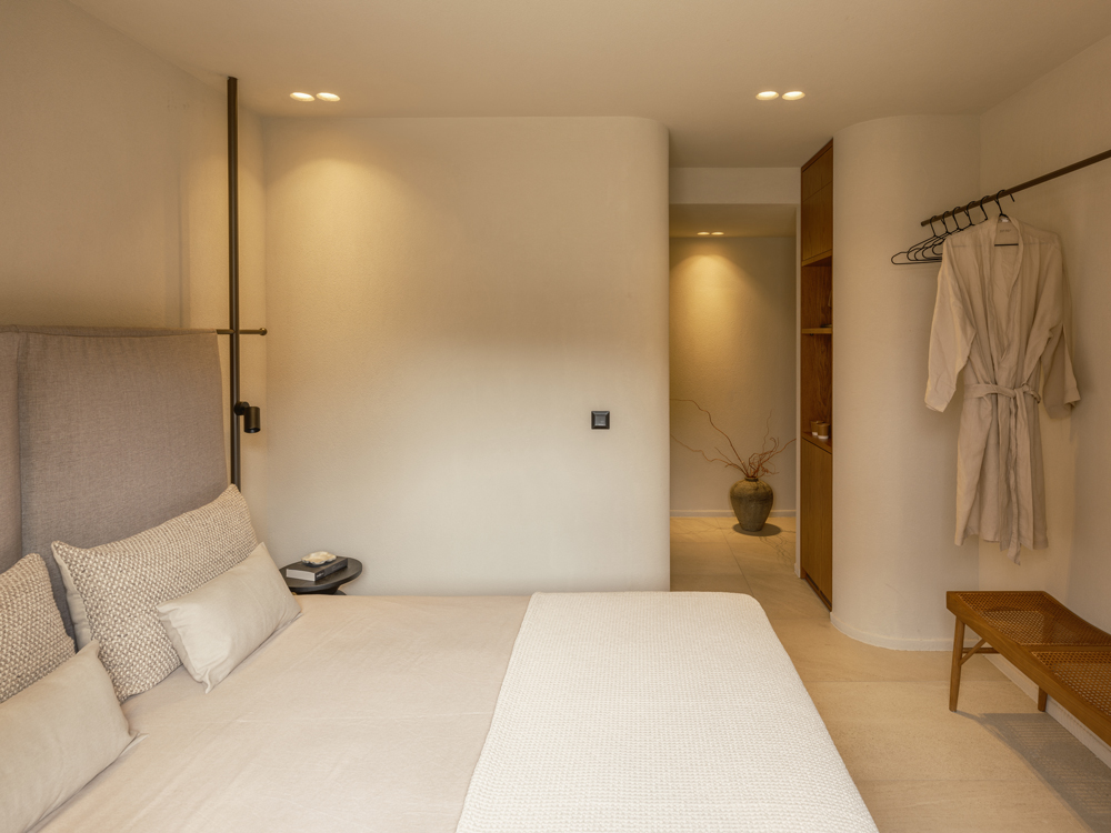 Bedroom with custom metal headboard and natural material palette.