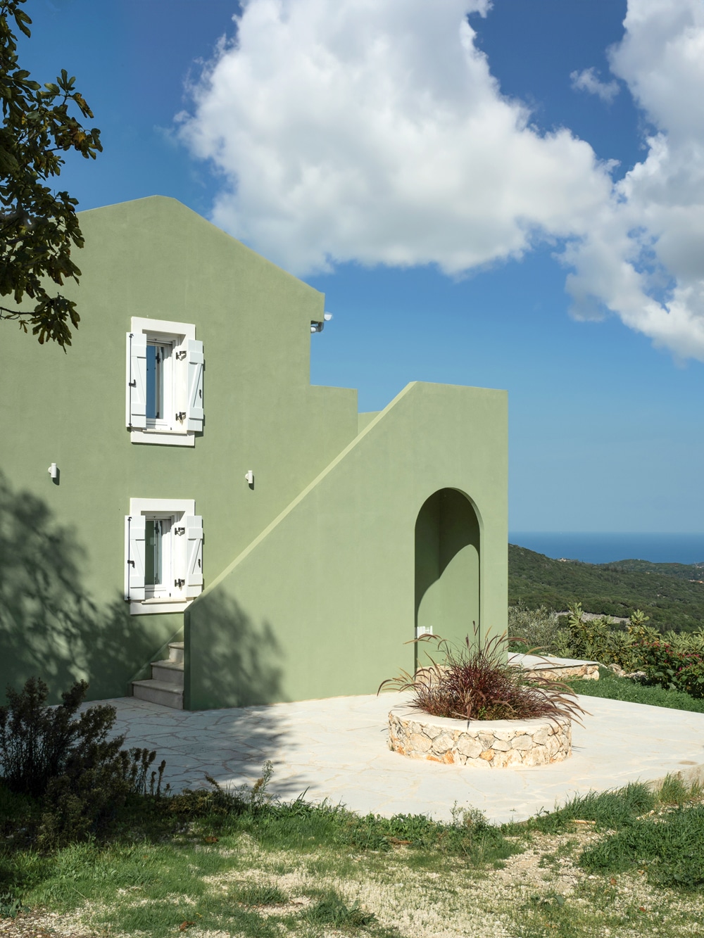 Front elevation of the 60-square-metre family house with external staircase and arched opening