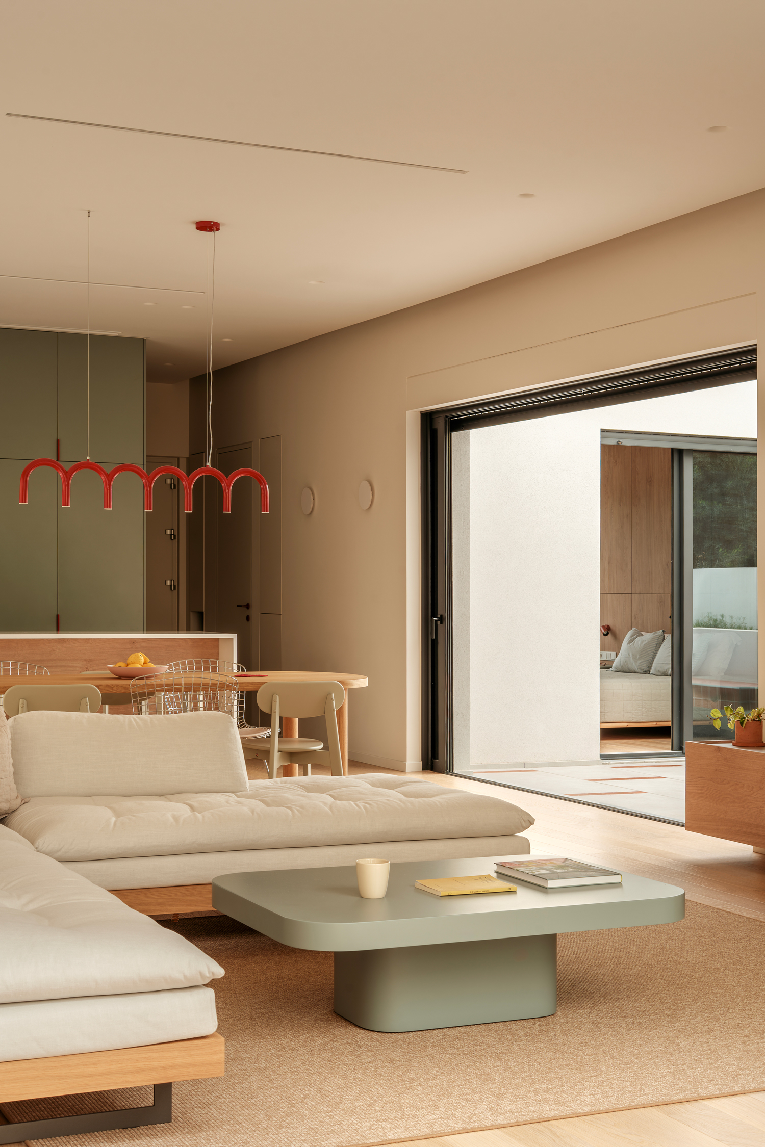 Open-plan living, dining and kitchen area opening onto a sheltered patio