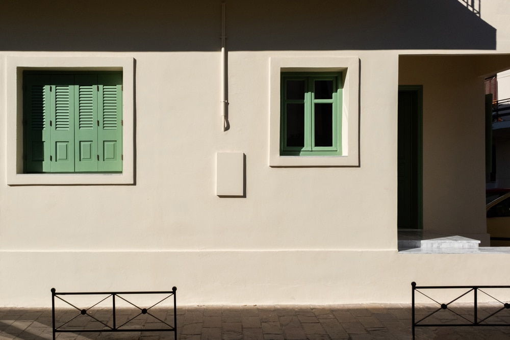 Exterior view of the renovated apartment with pale green window frames