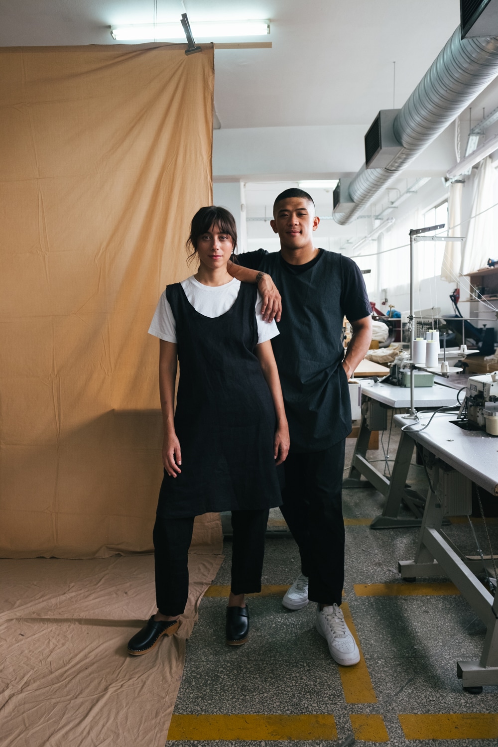 Uniforms made from reclaimed hotel sheets displayed in the studio