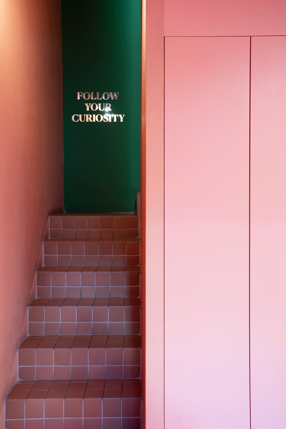 The upper level features a quieter seating area surrounded by greenery.