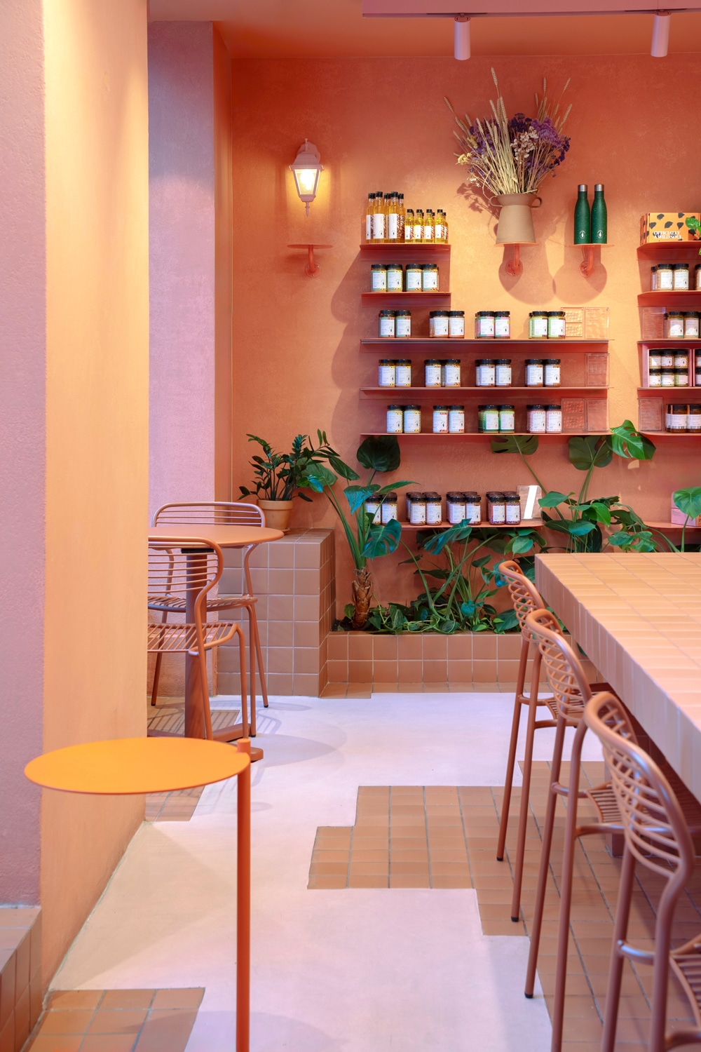 Dense planting transforms the first floor into a calm retreat above the street.