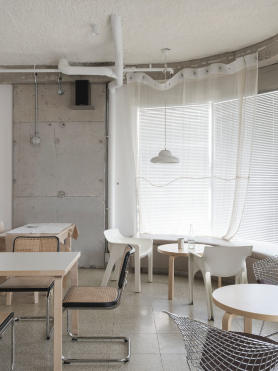 Beachside restaurant interior showing mix of industrial materials and warm lighting in Sydney