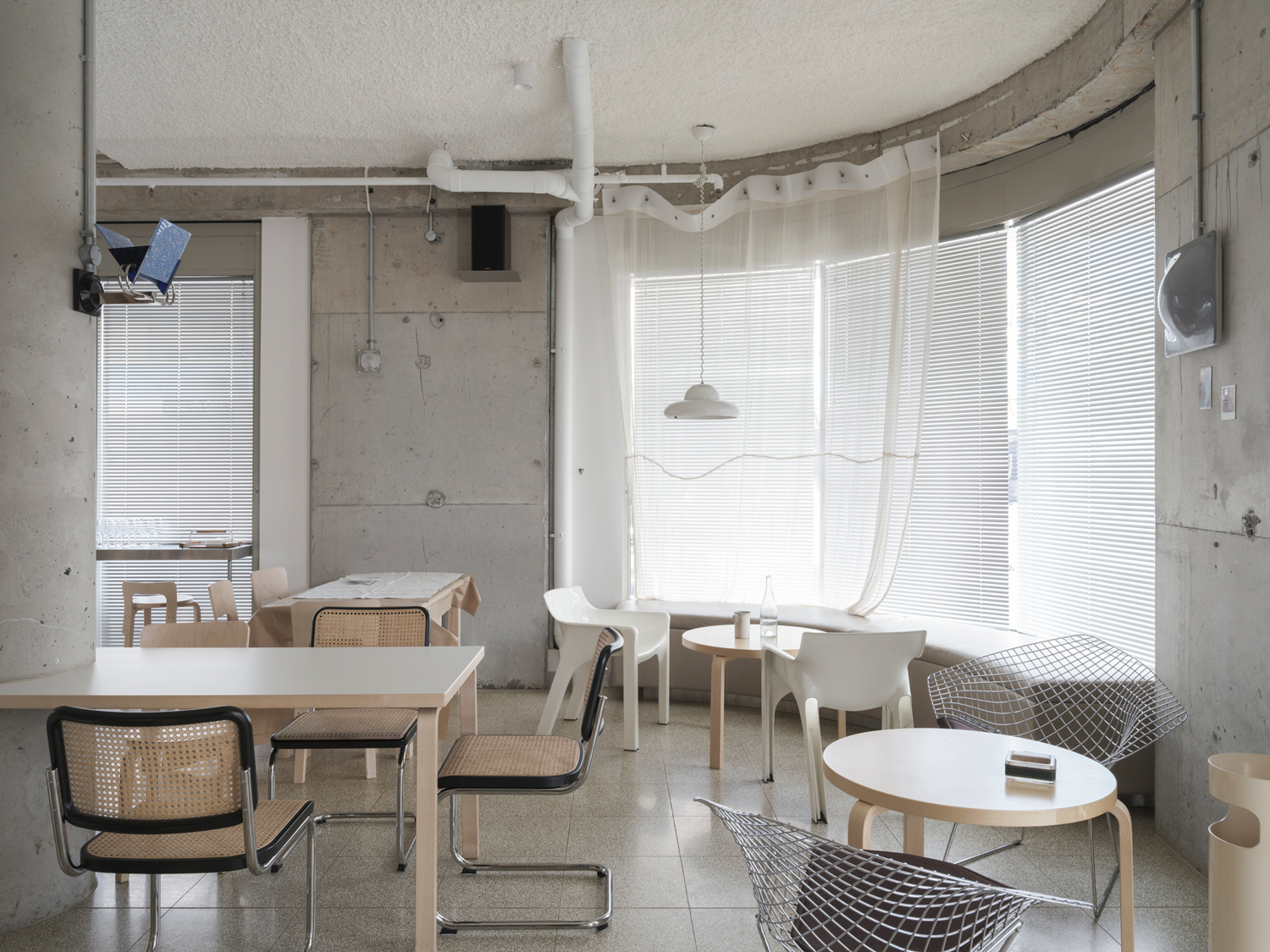 Beachside restaurant interior showing mix of industrial materials and warm lighting in Sydney