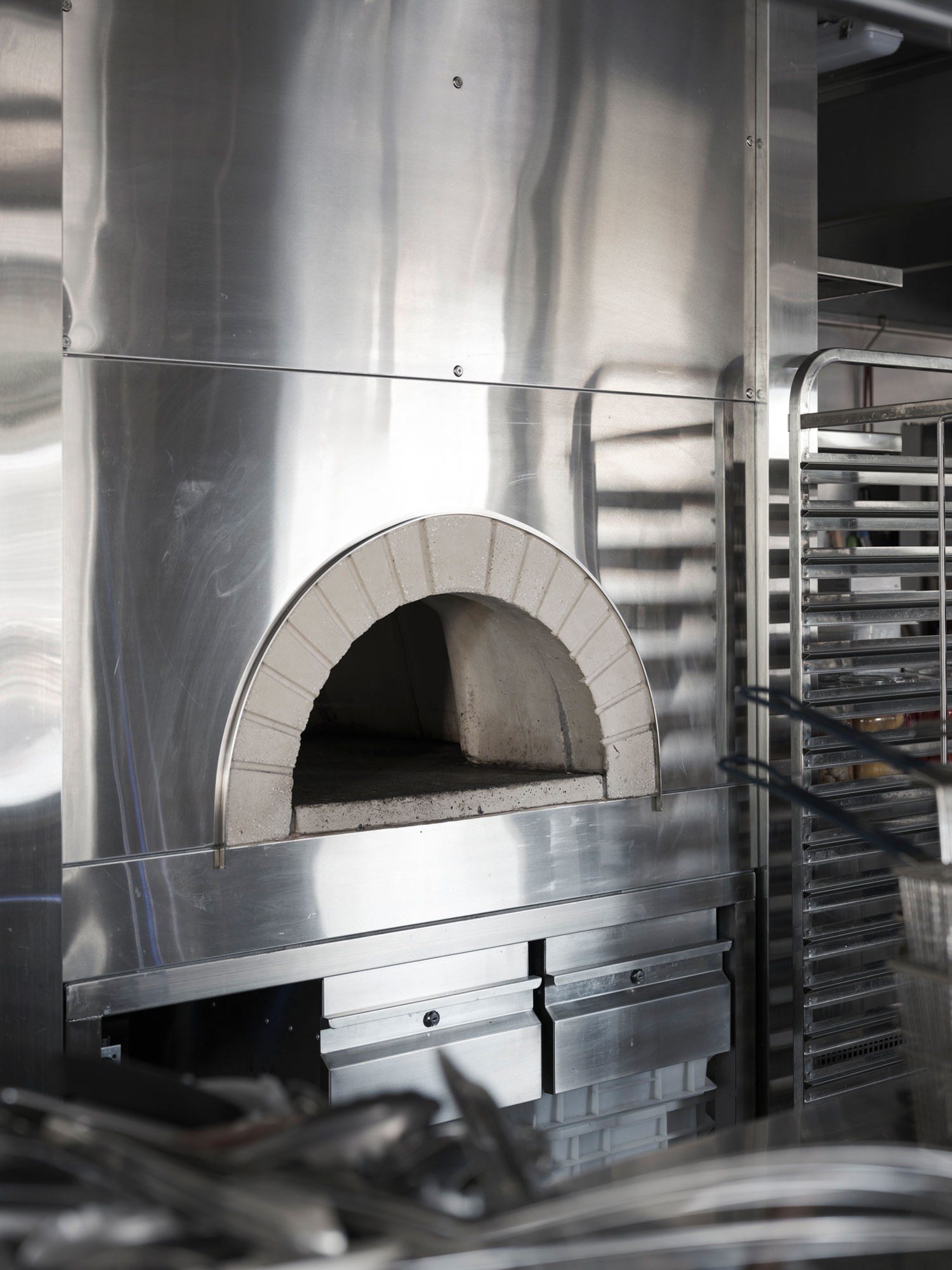 Stainless steel kitchen at Homer Rogue Taverna by AP Design House