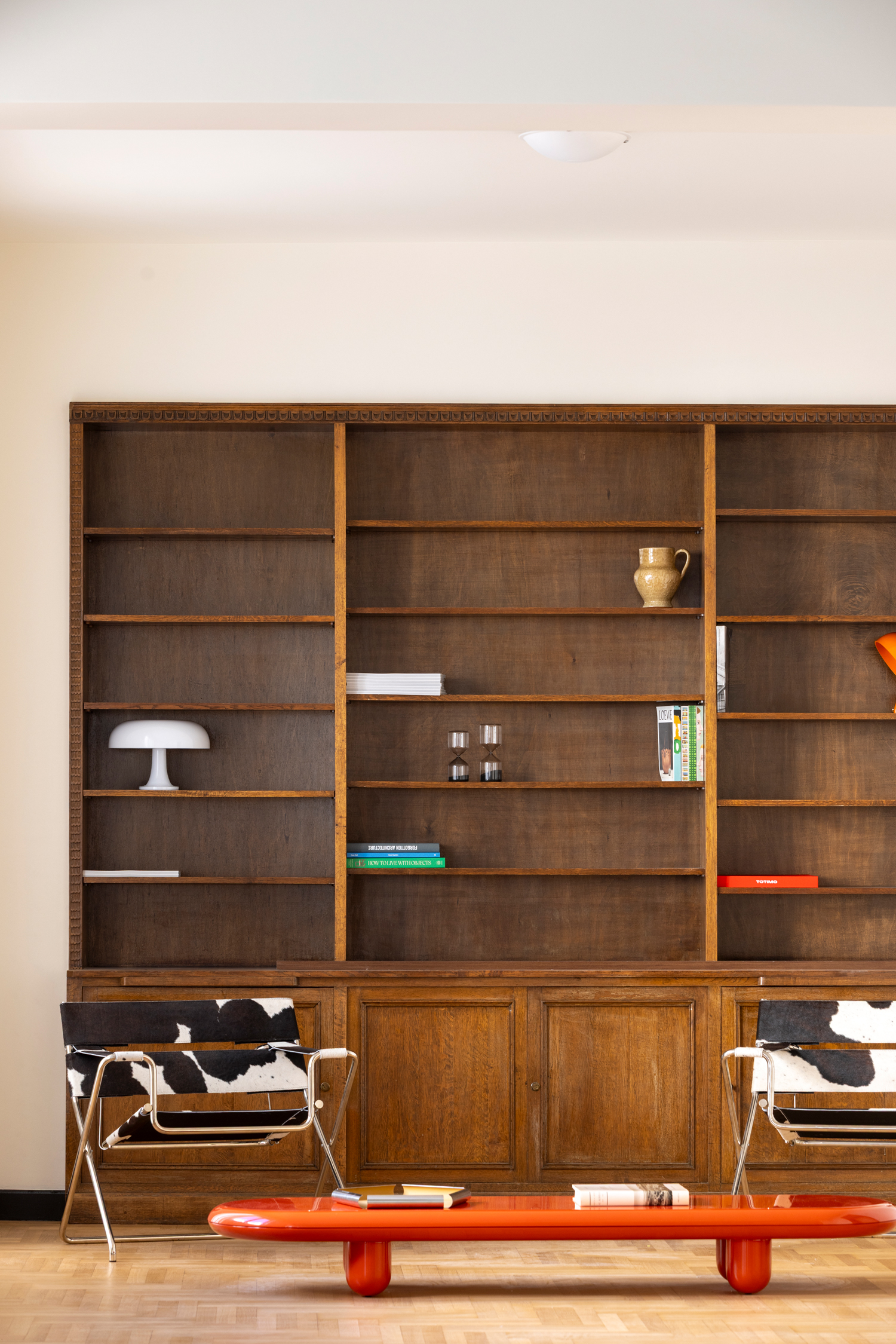 Interior corner showing wooden bookcase and natural light across materials