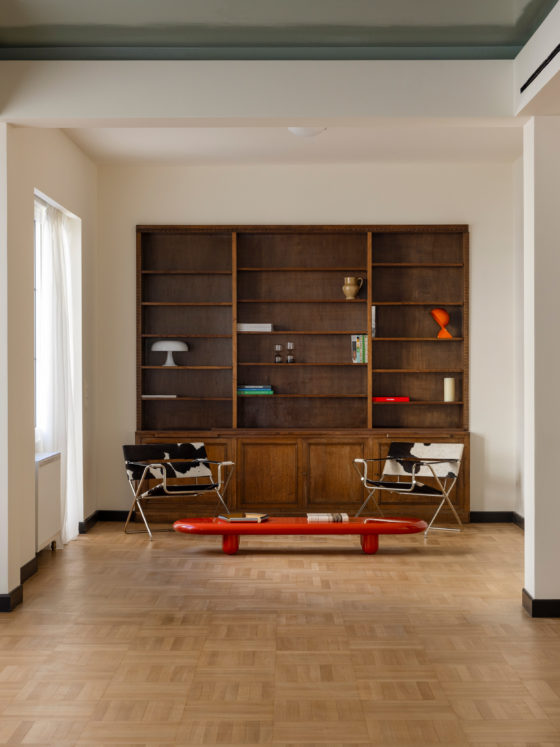 Living area with original oak flooring and red marble fireplace in renovated Kolonaki apartment