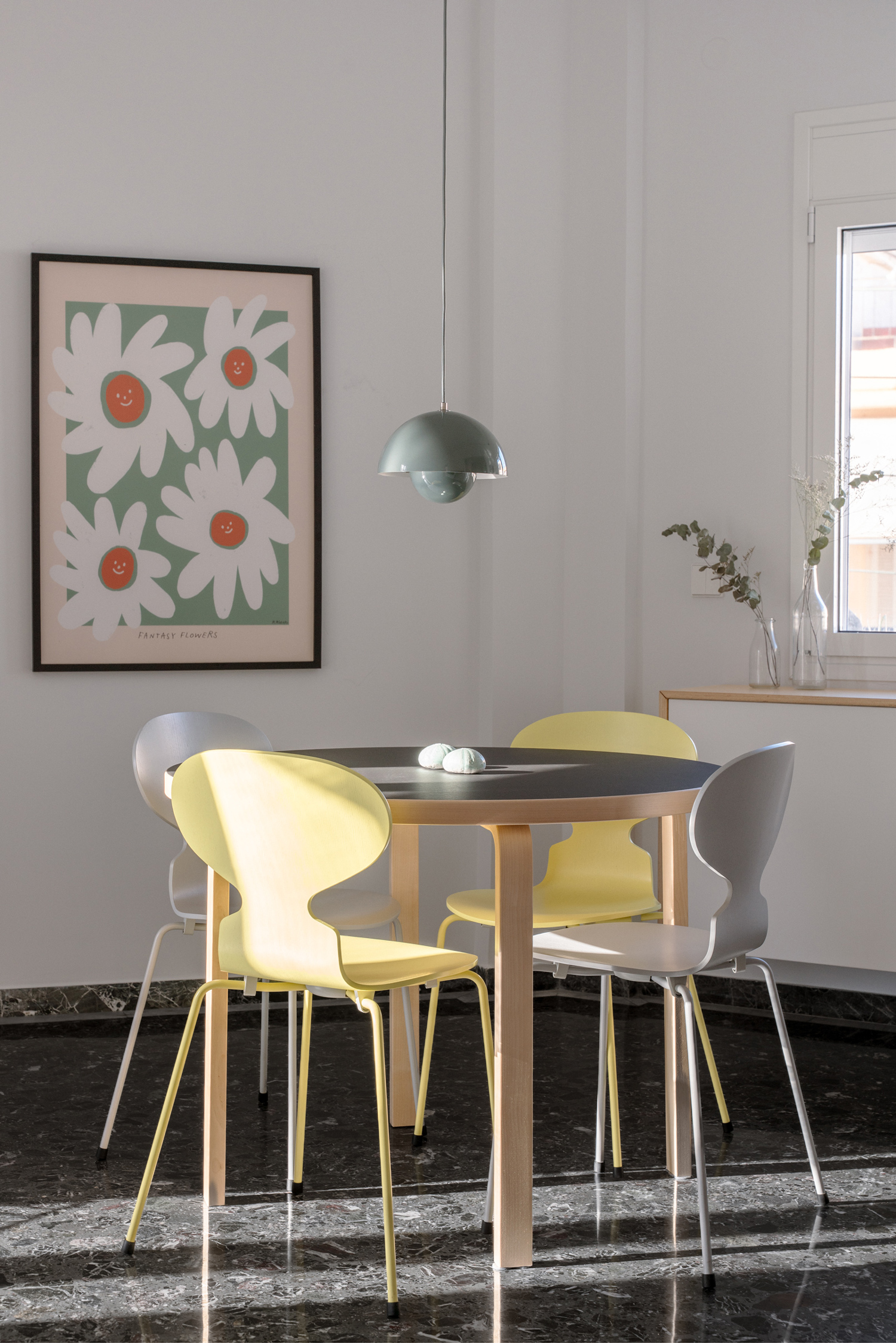Dining area aligned with kitchen island under pendant lighting