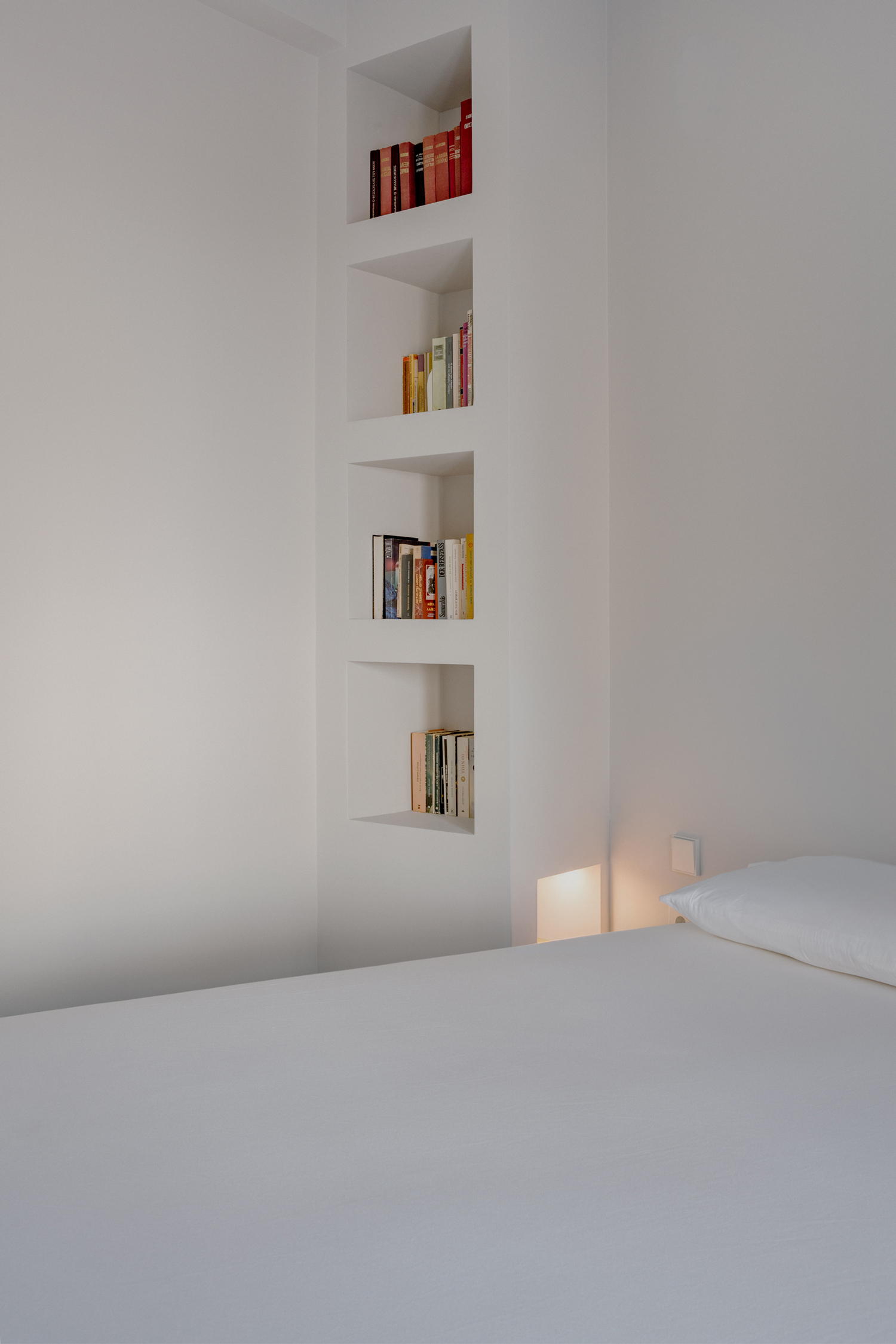 Bedroom in soft beige tones facing courtyard