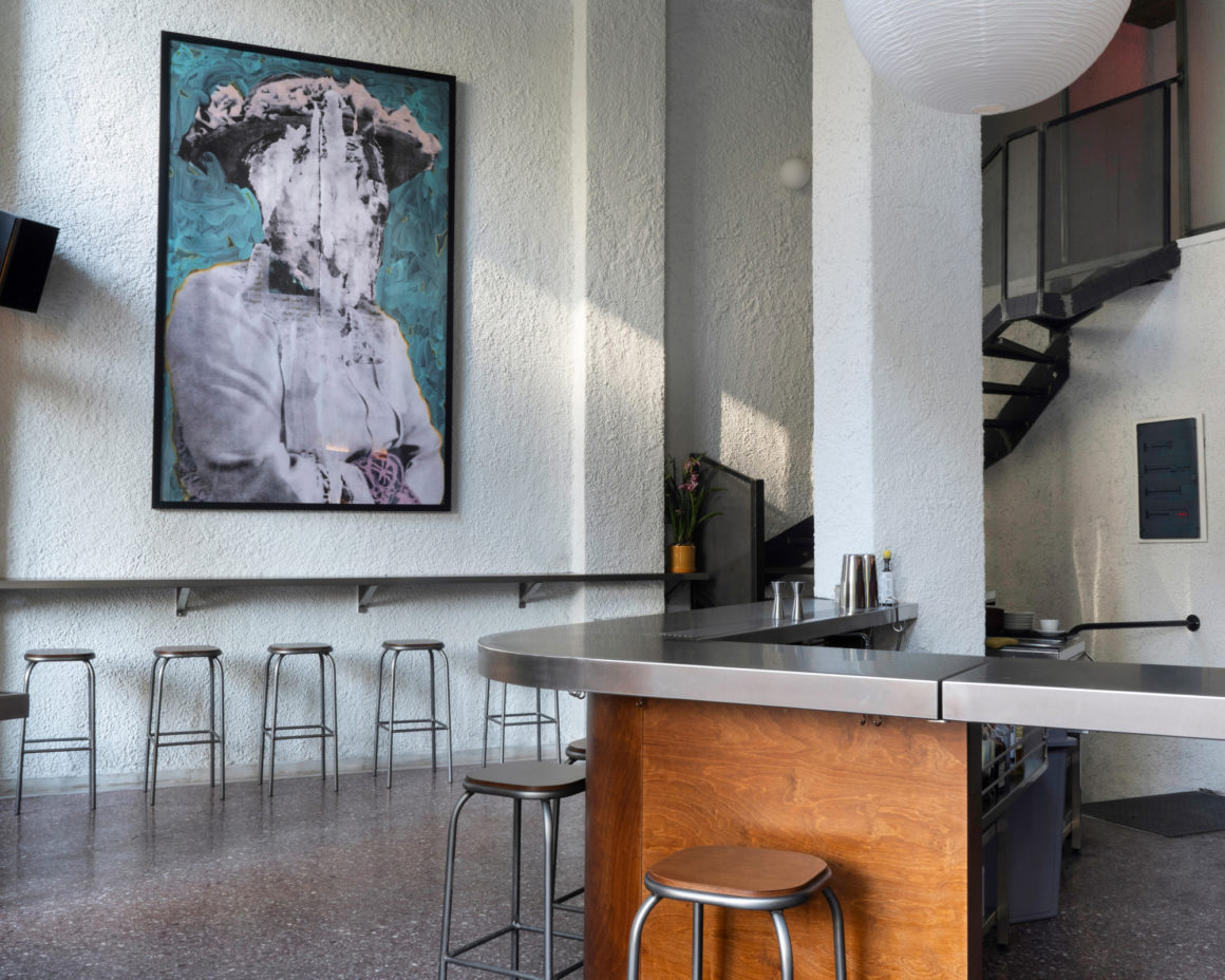 Interior of Karate bar showing diagonal stainless steel counter and terrazzo floor