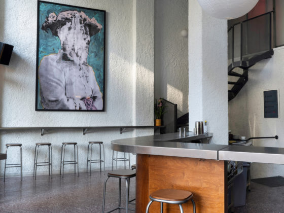 Interior of Karate bar showing diagonal stainless steel counter and terrazzo floor