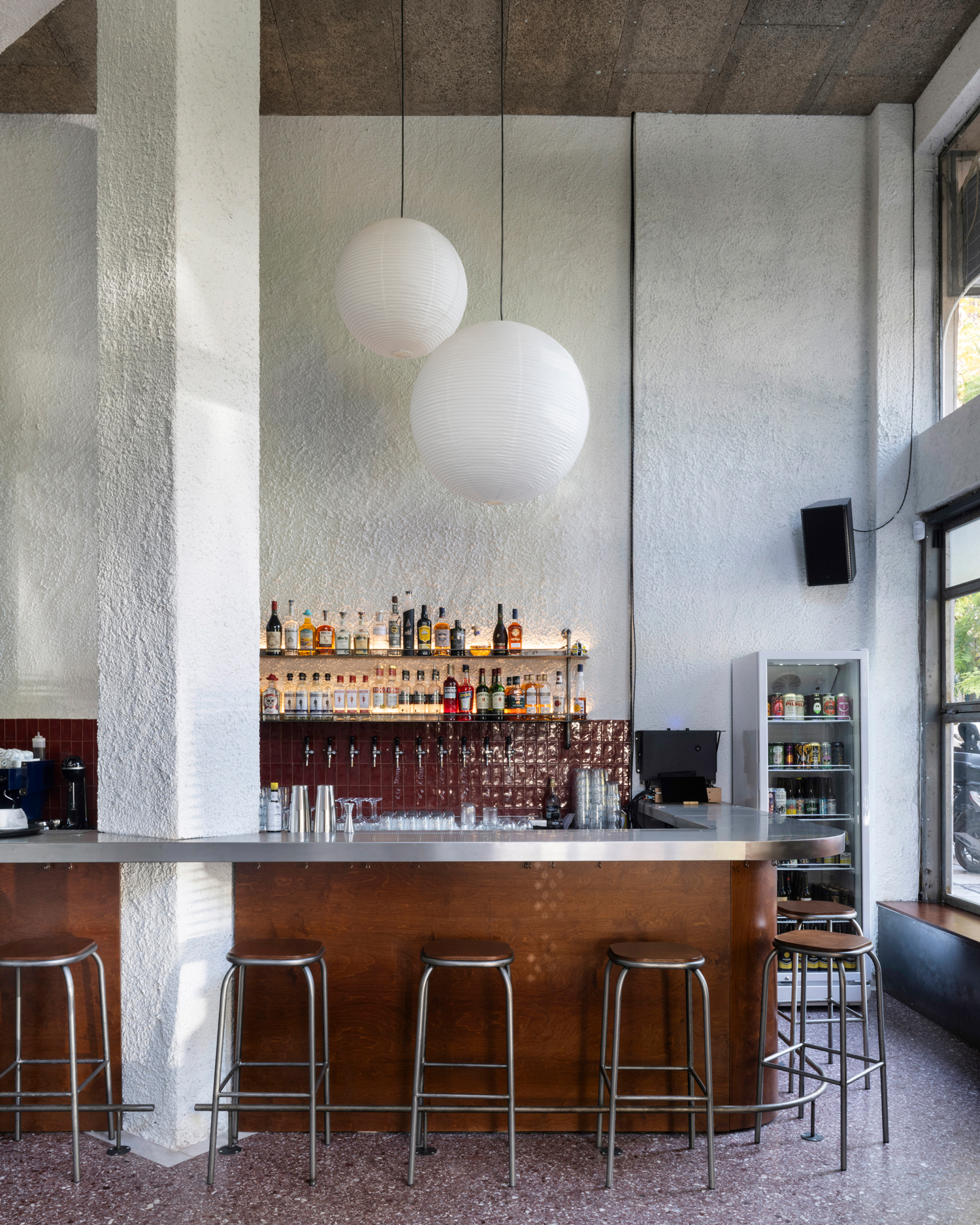 View of the bar area with oversized paper pendant lights suspended above the counter