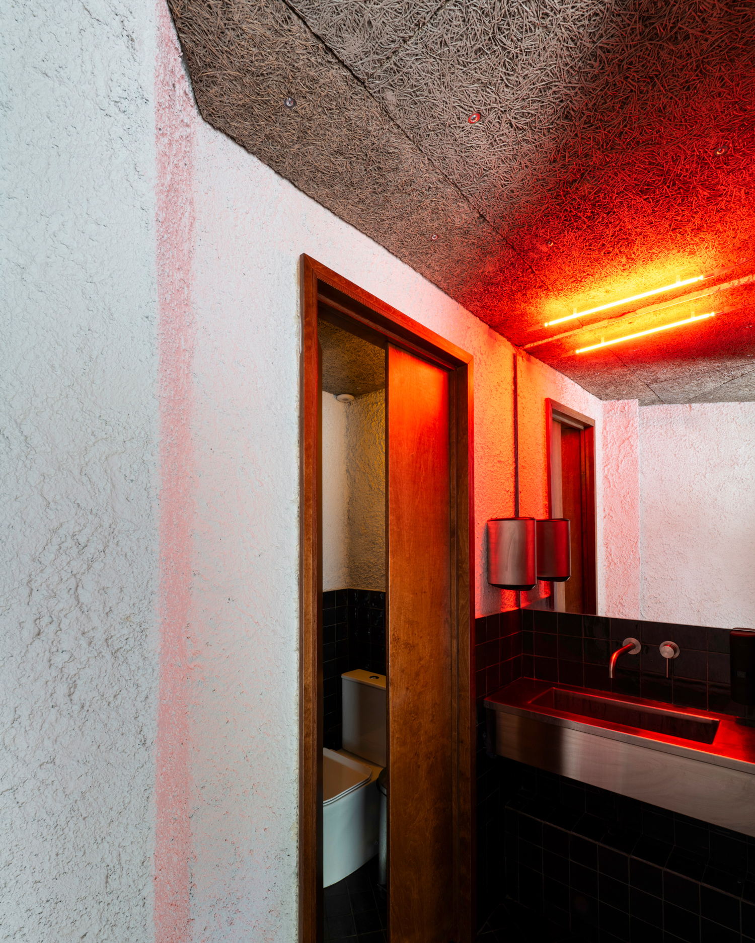 Detail of rough cast plaster wall and warm wooden surfaces