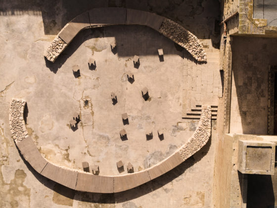 Circular dry-stone installation forming a communal table at the Malta Biennale entrance