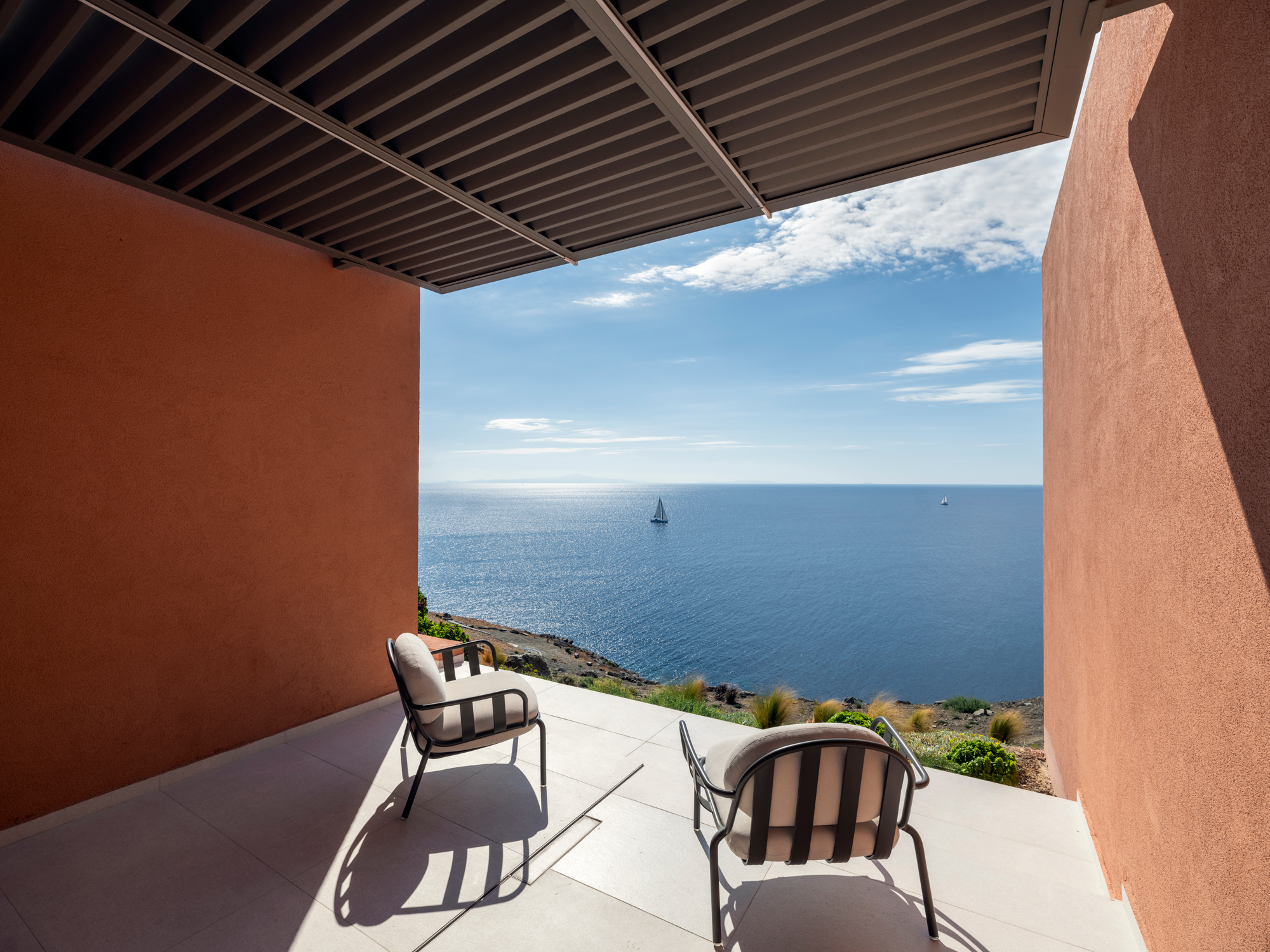 Private terrace at Olen Syros with sea views and outdoor living space overlooking the Aegean.