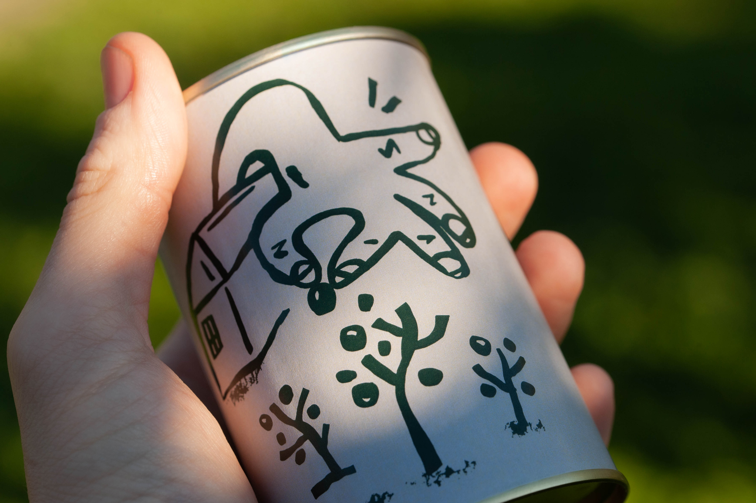 Handwritten illustration on Slab olive oil label showing hand picking olives