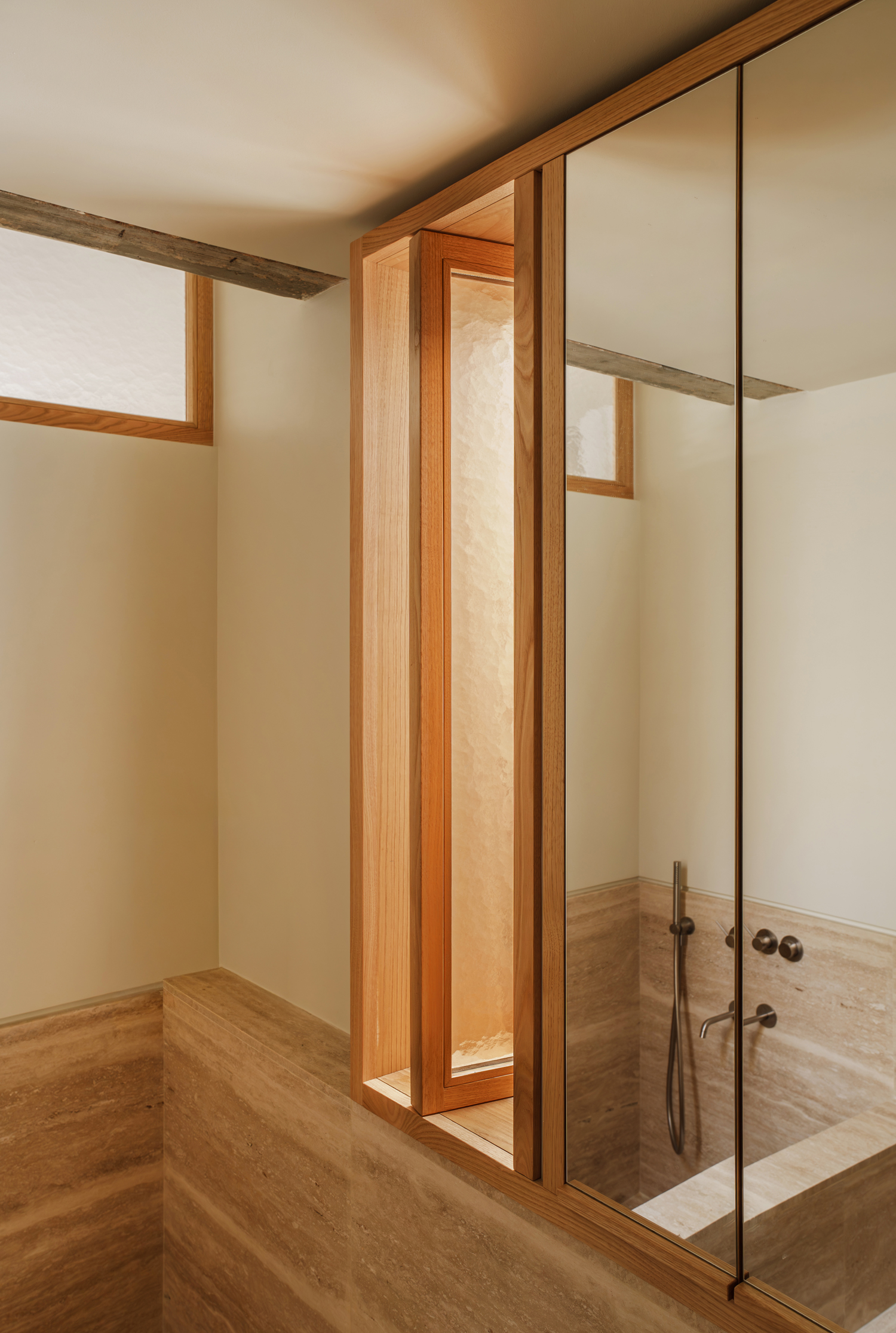 Bathroom with marble surfaces and natural light in renovated Athens apartment