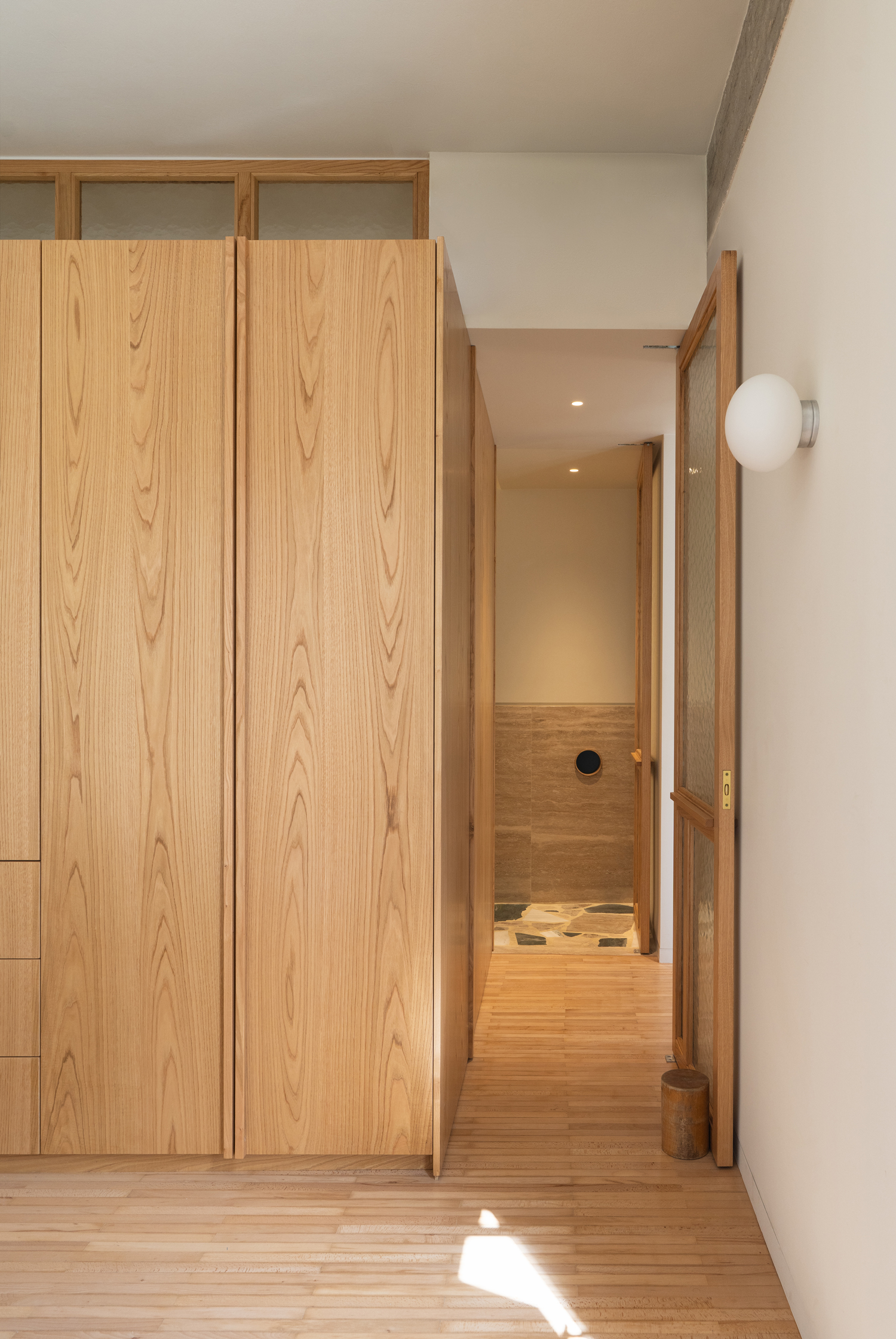 Bedroom with integrated storage and timber flooring in Athens apartment