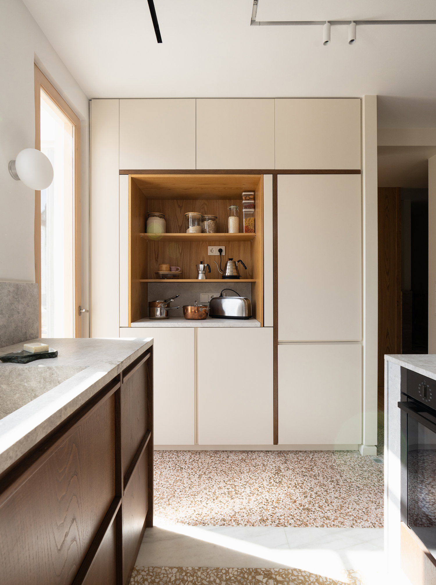 Marble kitchen countertop and cabinetry in renovated Patissia apartment interior
