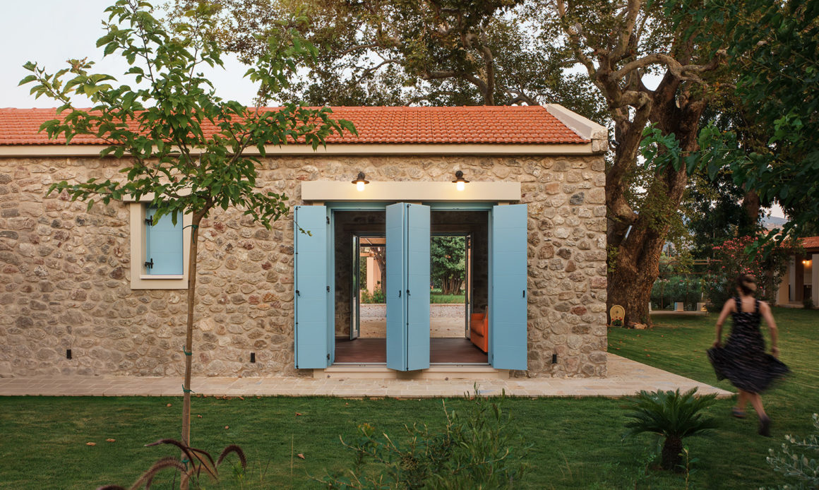 Exterior view of Villa Roja surrounded by dense greenery in Patras