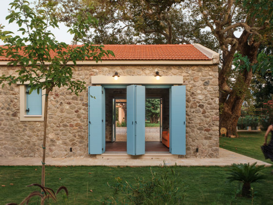 Exterior view of Villa Roja surrounded by dense greenery in Patras