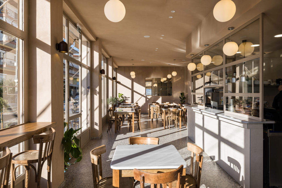 Interior view of FAI restaurant in Veroia with curved walls, terrazzo flooring and central open kitchen